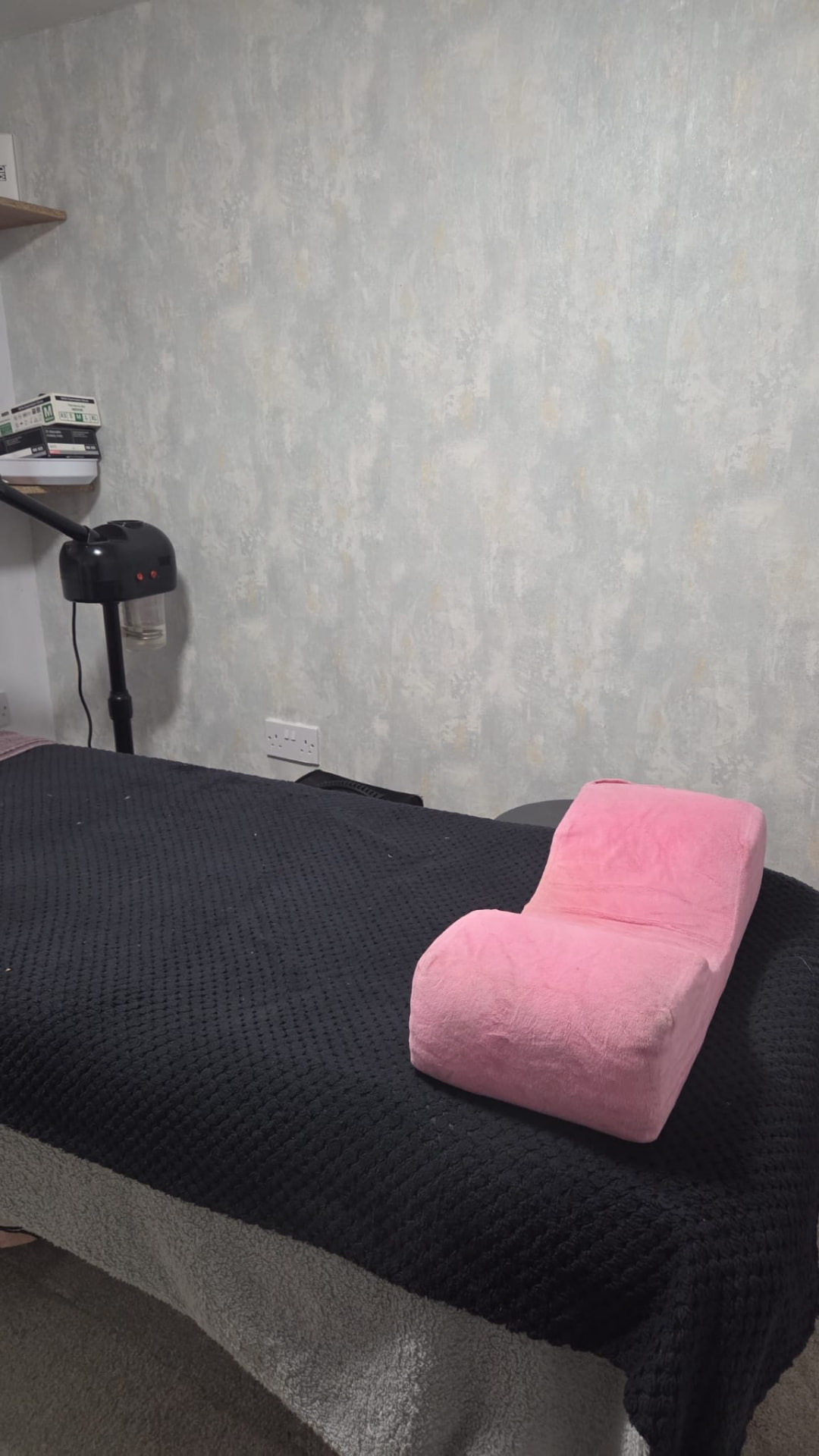Treatment couch with a lash pillow and facial steamer
